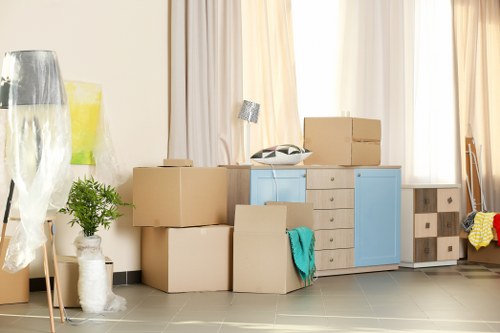 Professional movers preparing an upright piano removal in Battersea